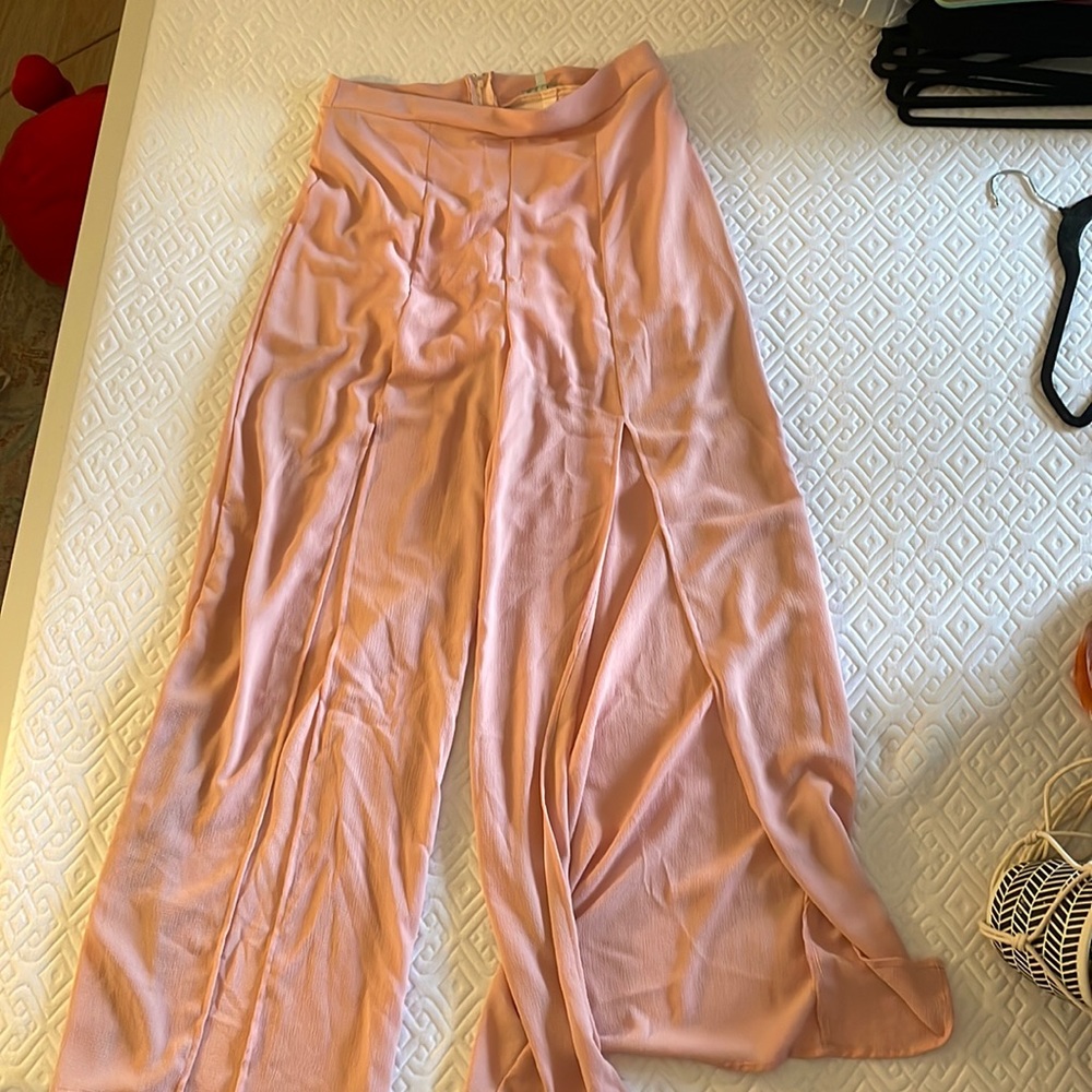 Blush colored wide-legged, high waisted pants.